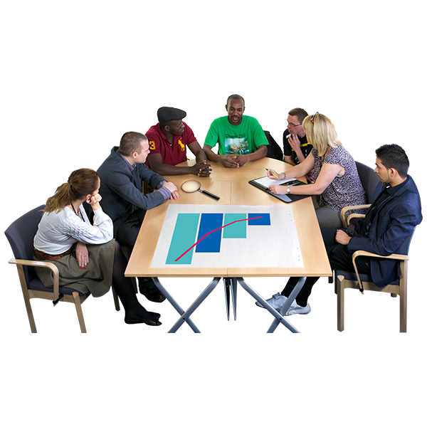 A group of people sit around a table with a large bar chart on it